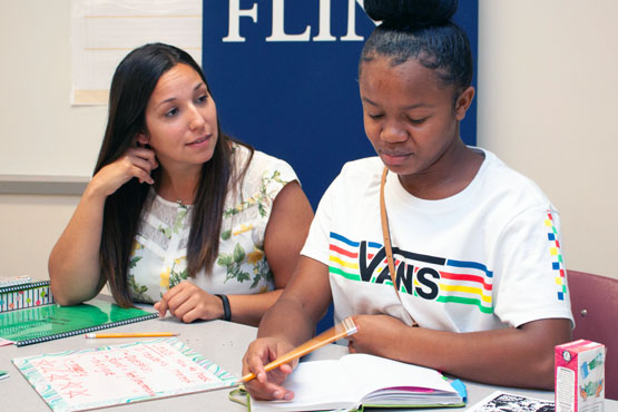 SEHS student helping a child with homework.