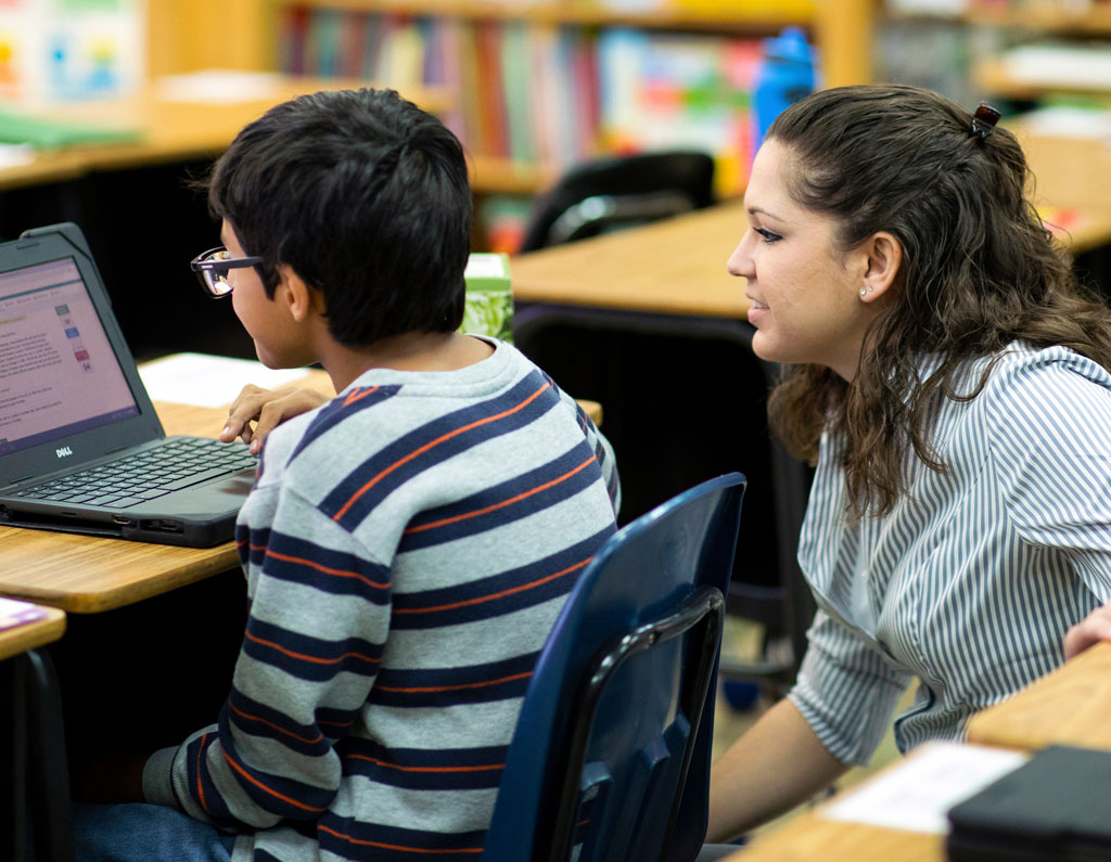Teacher helping a student in a classroom