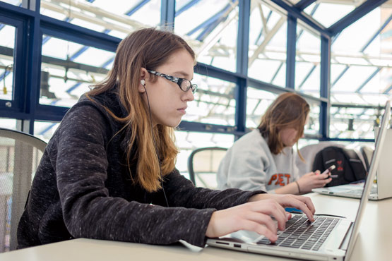 Two students working on laptops.