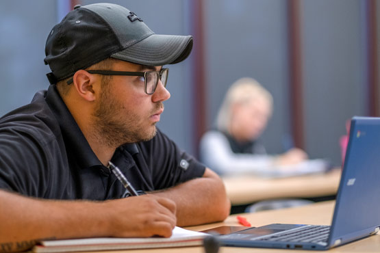 Student sitting in a communications class at the University of Michigan-Flint.