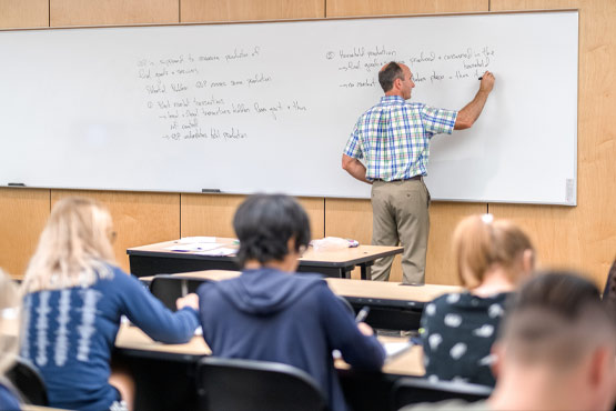 Economics faculty teaching a class at the University of Michigan-Flint.