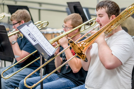 Students playing instruments during a music class at the University of Michigan-Flint.