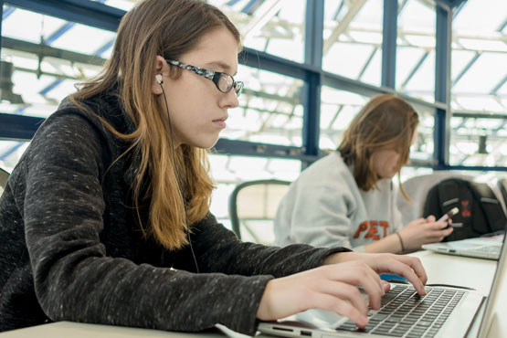 Two students working on laptops.