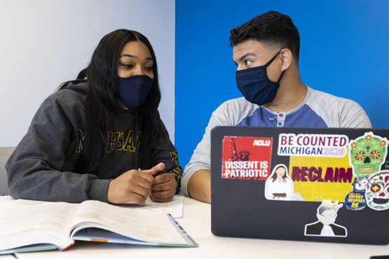 Two students working on computer