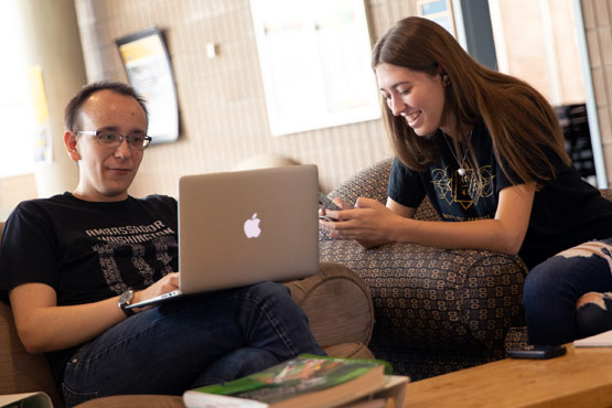Two students working on computer