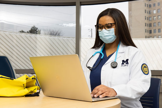 School of Nursing student working on laptop.