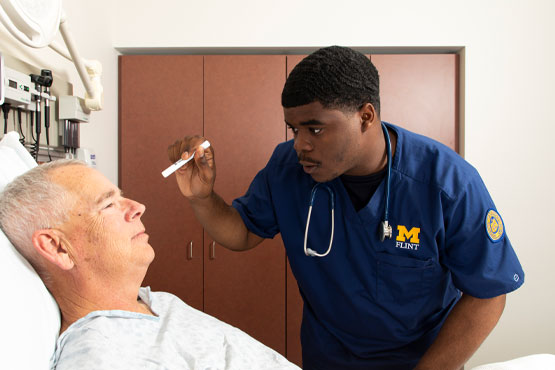 School of Nursing student working with a patient.