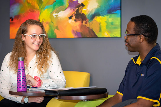 Two UM-Flint School of Management OBHRM students discussing class.