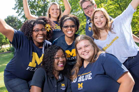 Group of seven students outside smiling.