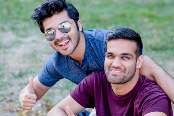 Two students smiling.